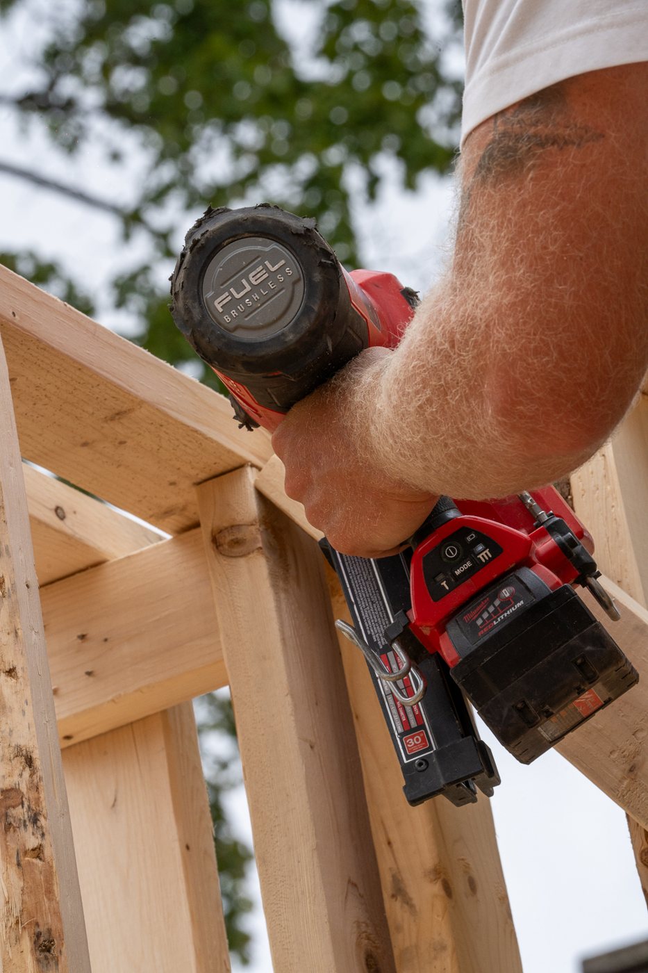 A Halpern & Co. framer driving nails into a stud wall on site