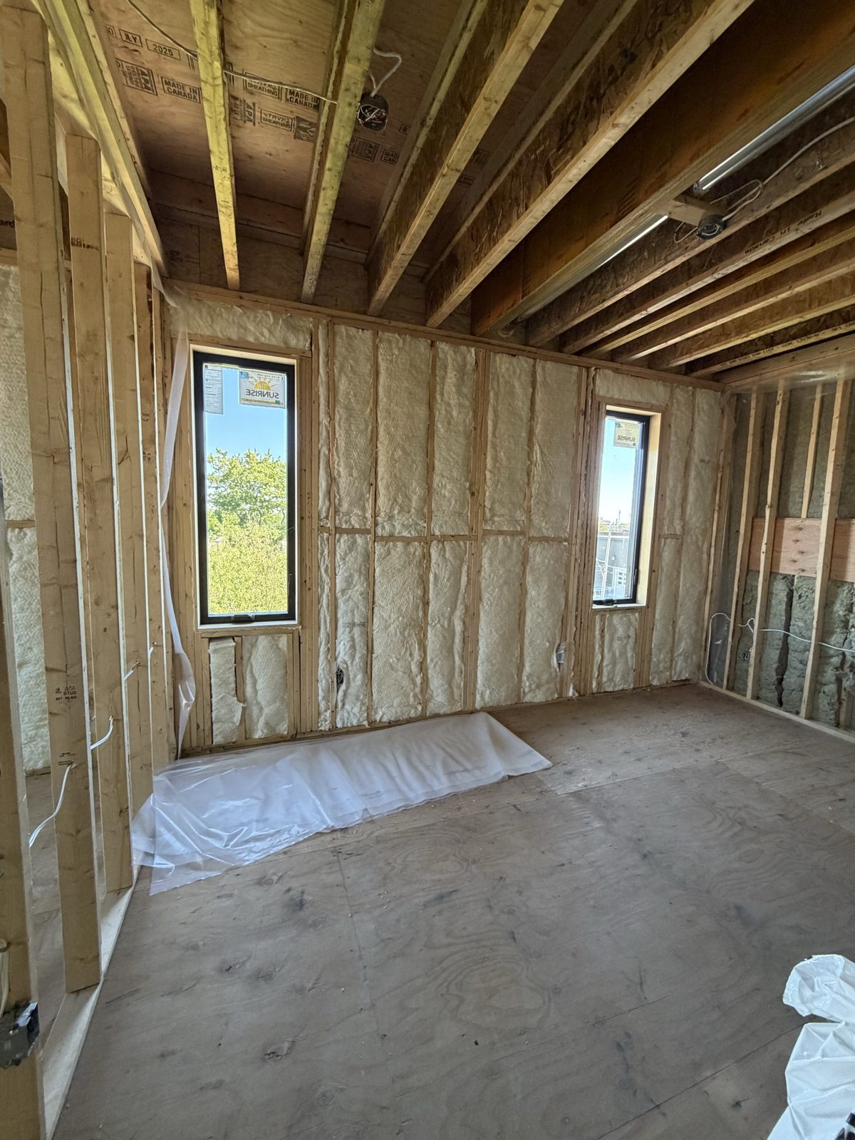 Spray-foam insulated interior with new windows at the Knox Avenue build
