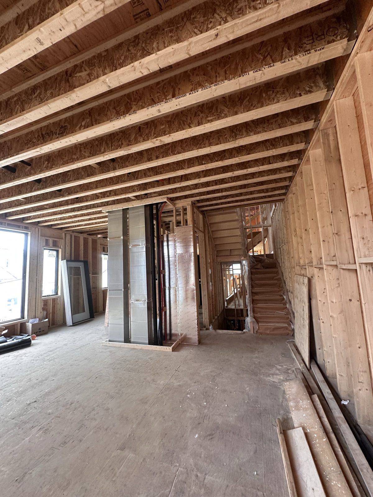 Floor joists and stair framing inside the Knox Avenue build